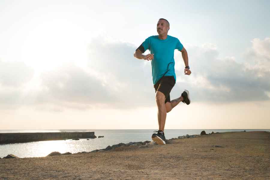 how do i maintain a consistent routine - man running on beach