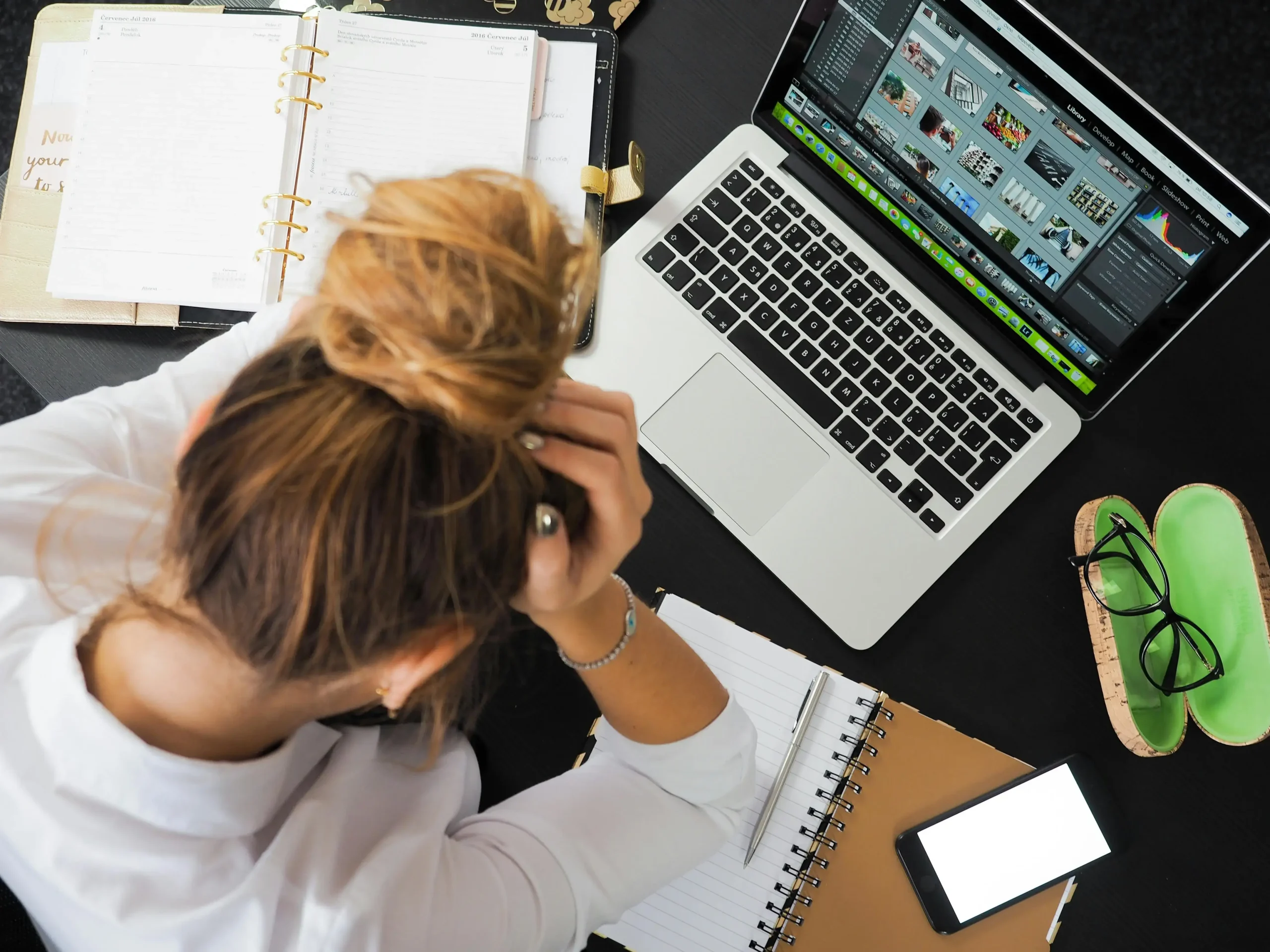 Woman overwhelmed at work in front of her laptop